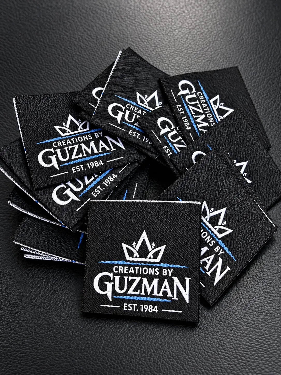 Black Creations by Guzman woven labels with crisp white and blue detail