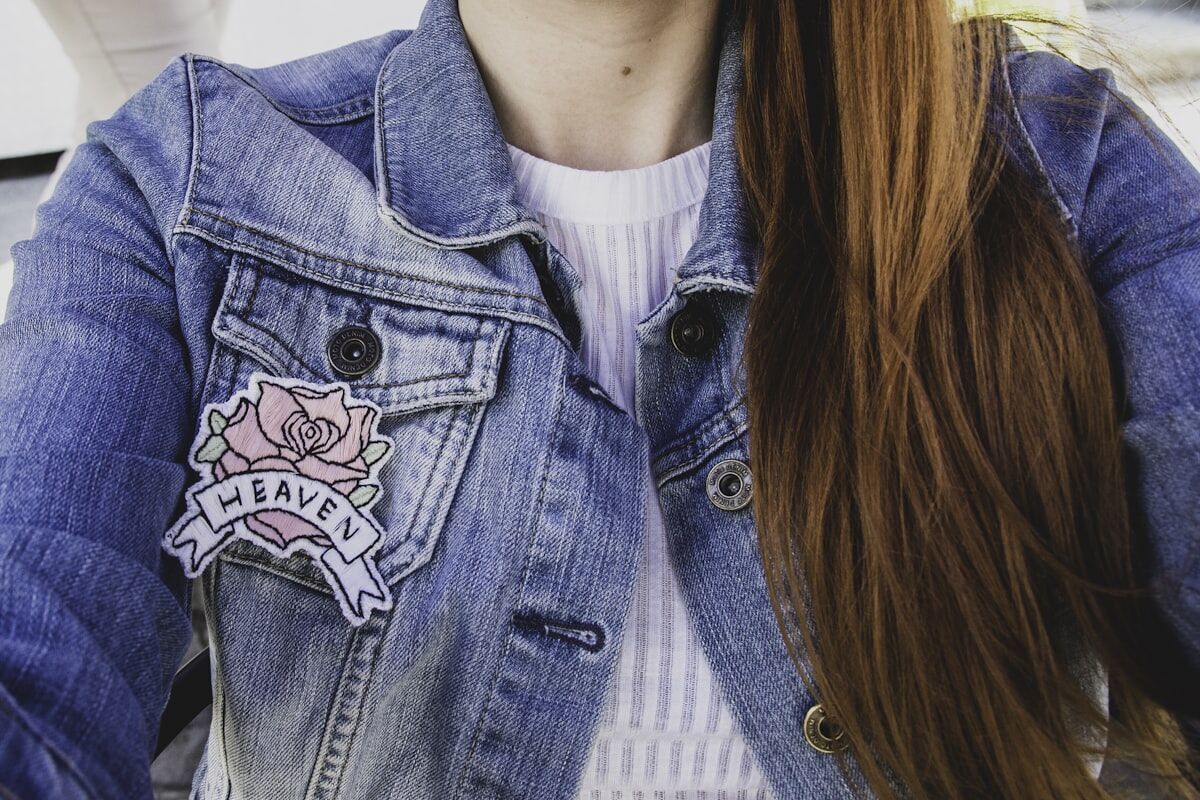 Embroidered rose patch on a denim jacket