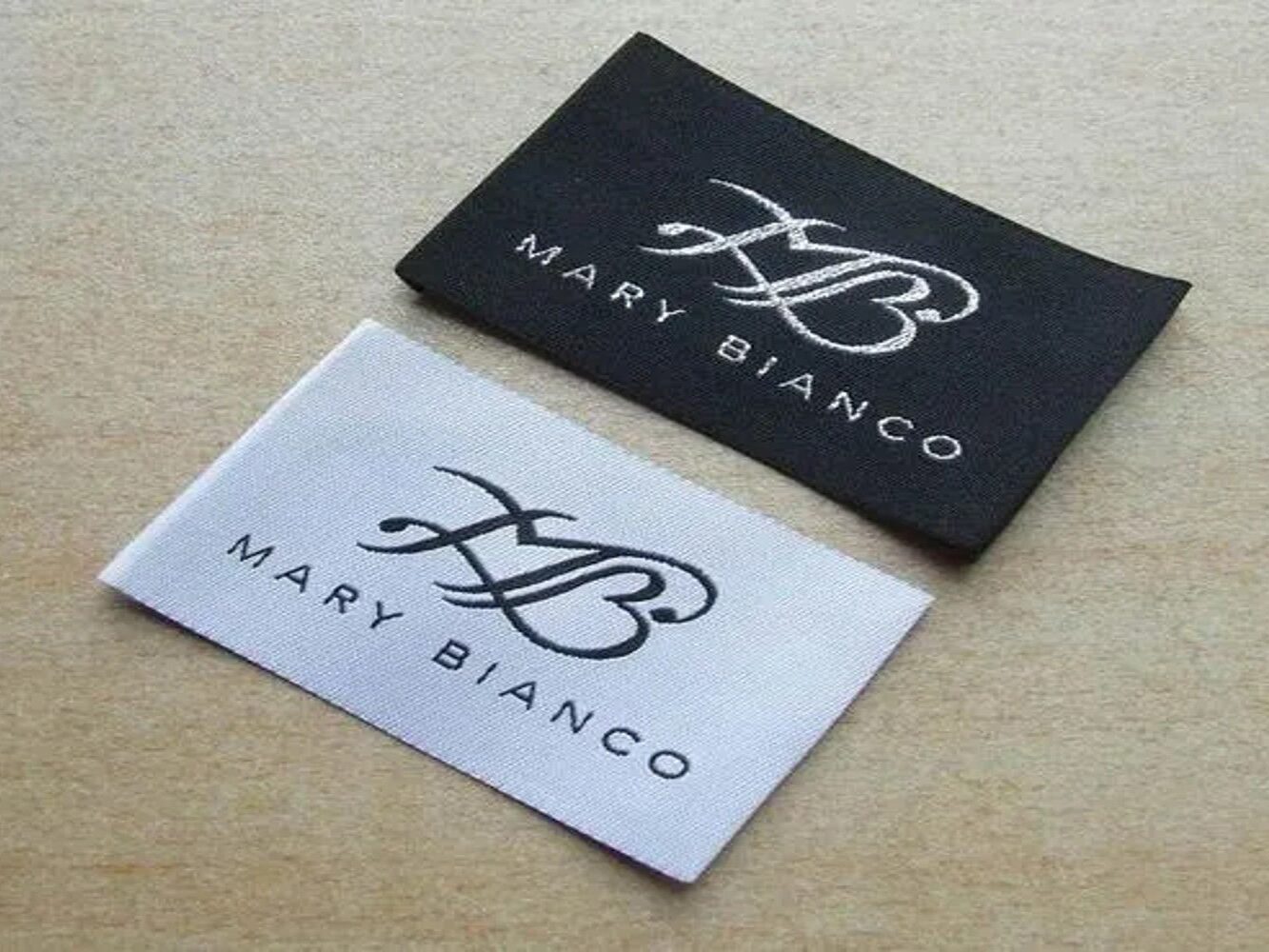 Flat woven damask clothing labels in black and white, ready to sew in